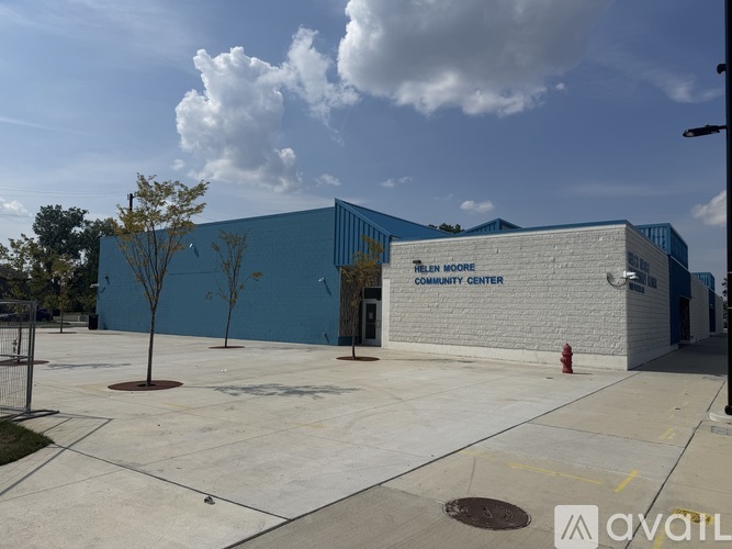 A community center with a blue and white exterior and a fire hydrant in front.