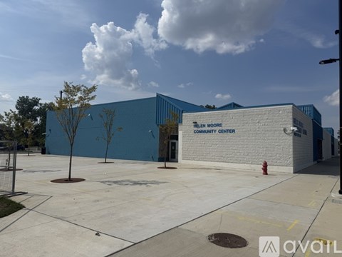 A community center with a blue and white exterior and a fire hydrant in front.