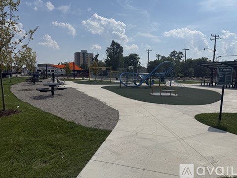 A playground with a slide and picnic tables.