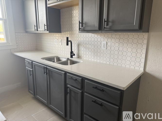 A kitchen with a sink and cabinets.