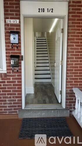 A black mat is on the front step of a house.