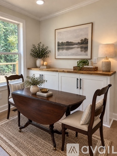 A dining room with a wooden table and chairs.