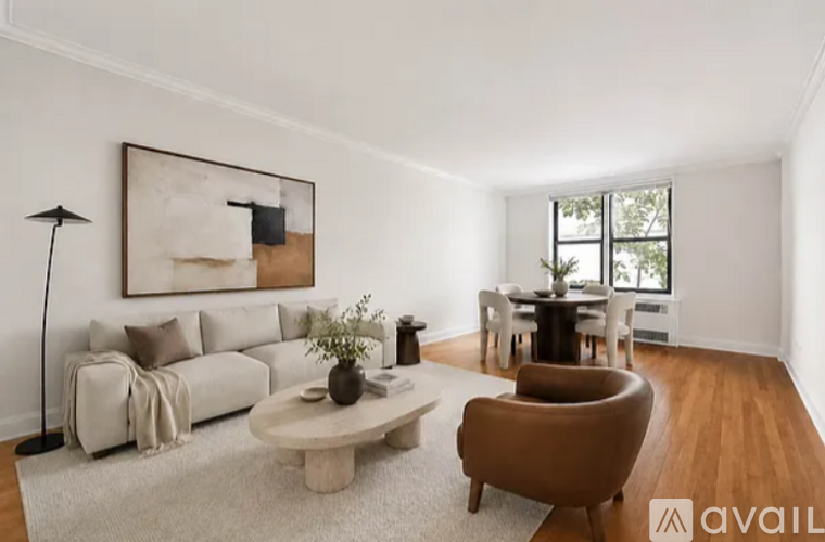 A living room with a white couch, a brown armchair, and a coffee table.