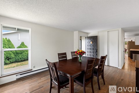 A dining room with a table set for four.