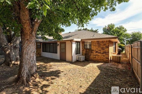 A house with a tree in front of it is for sale.