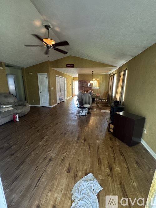 A living room with a ceiling fan and a couch.