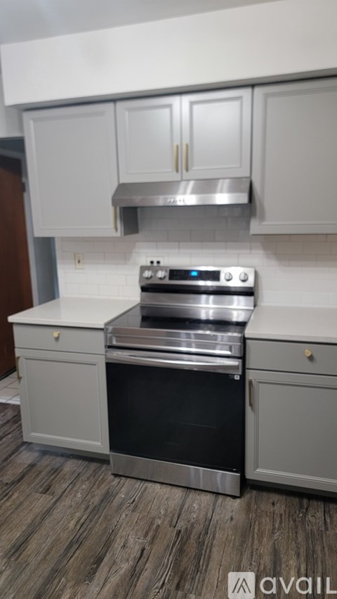 A kitchen with a stove top oven and a microwave.