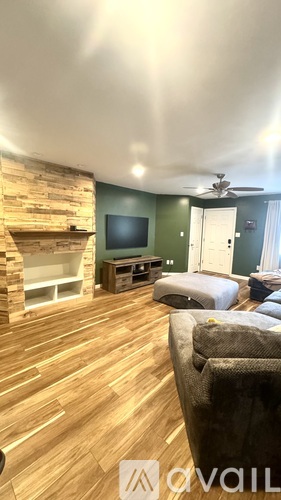 A living room with a fireplace and a television.