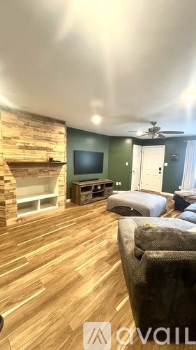 A living room with a fireplace and a television.