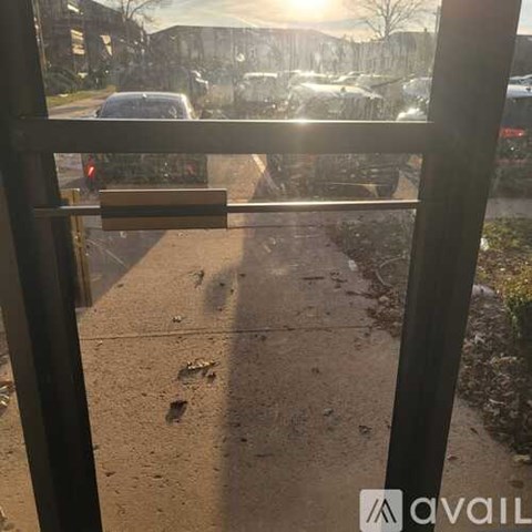 A view from inside a building looking out onto a wet sidewalk.