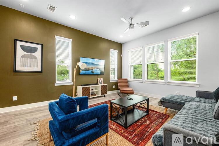 A living room with a blue chair and a black table.