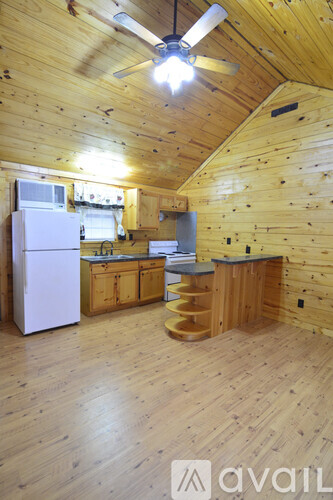 A kitchen with wooden cabinets and a white refrigerator.