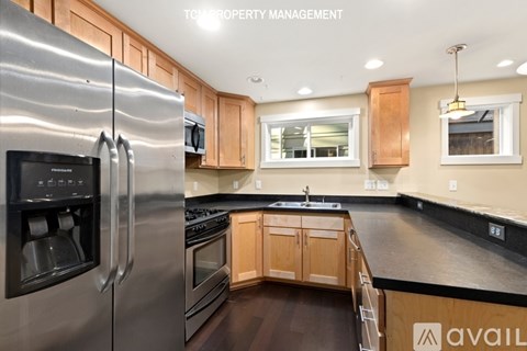 A modern kitchen with wooden cabinets and stainless steel appliances.