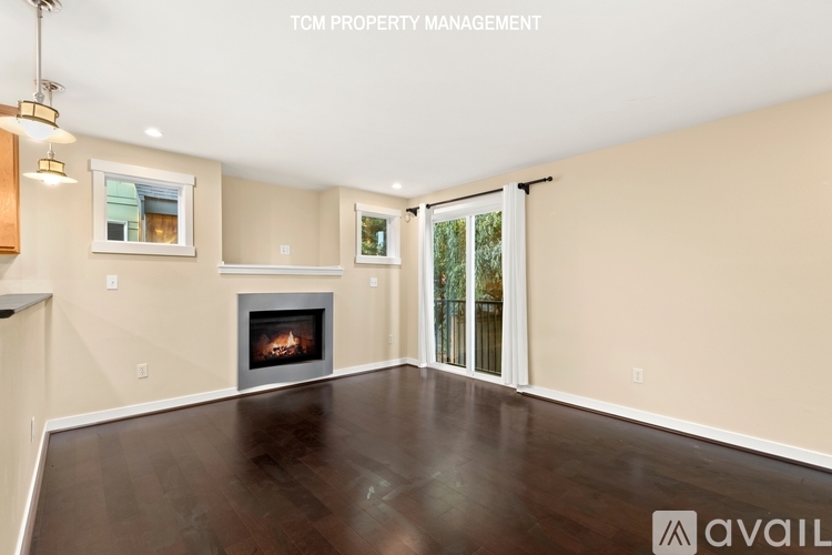 A spacious living room with a fireplace and sliding glass doors.