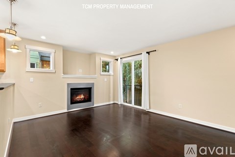 A spacious living room with a fireplace and sliding glass doors.