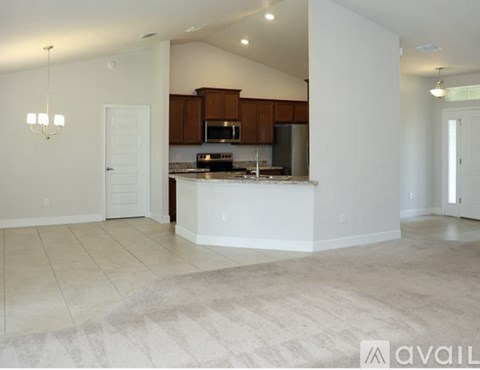 A kitchen with brown cabinets and a white island.