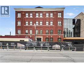 A red brick building with a black banner in front of it.