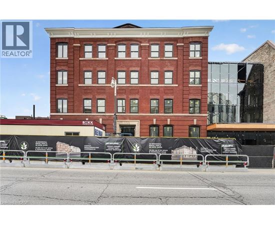 A red brick building with a black banner in front of it.