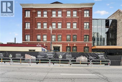 A red brick building with a black banner in front of it.
