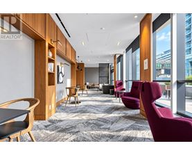 A modern office space with wooden furniture and a carpeted floor.