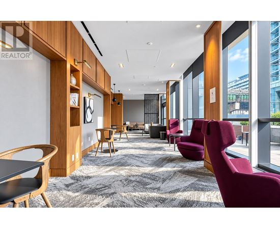 A modern office space with wooden furniture and a carpeted floor.