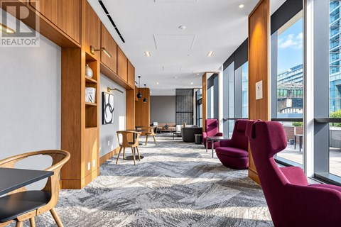 A modern office space with wooden furniture and a carpeted floor.