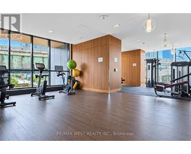 A gym with a view of the city outside the windows.