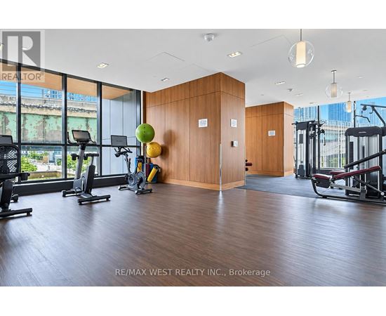 A gym with a view of the city outside the windows.