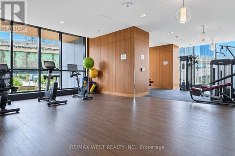 A gym with a view of the city outside the windows.