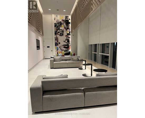 A modern living room with a grey sofa and a coffee table.