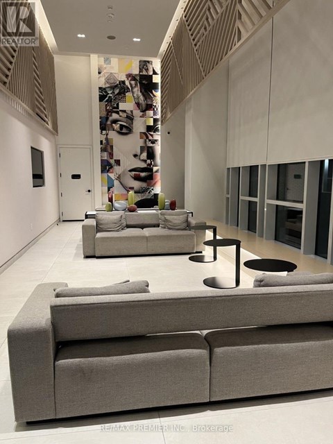 A modern living room with a grey sofa and a coffee table.