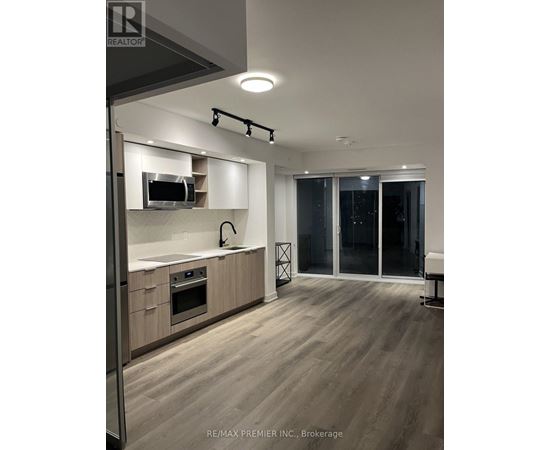 A modern kitchen with wooden floors and a large island.