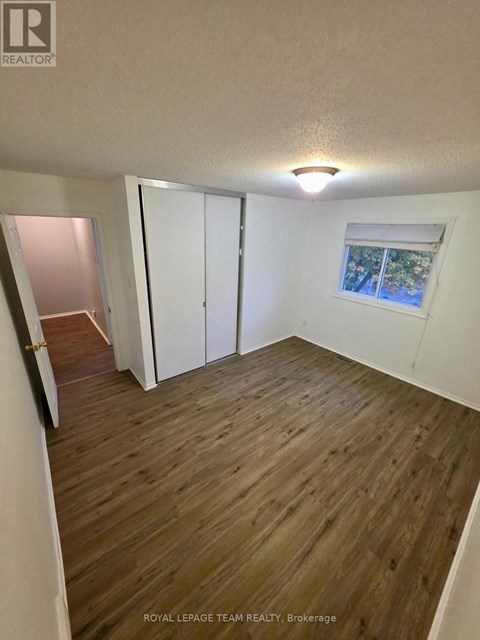 A room with wooden flooring and white walls.