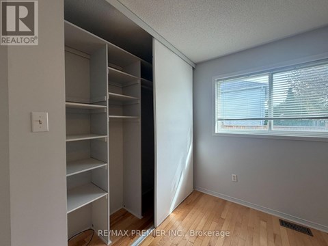 A room with a large closet and a window.
