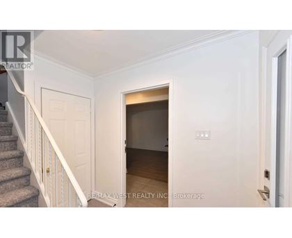 A white door with a small window in the middle of a hallway.