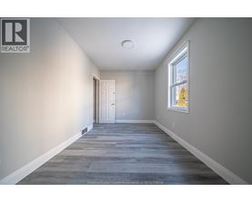 A long, empty hallway with a door at the end.
