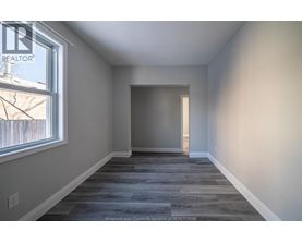A room with a grey floor and a window.