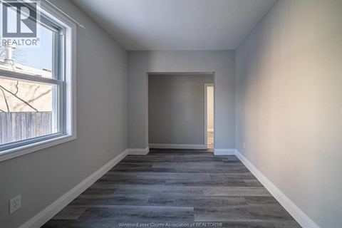 A room with a grey floor and a window.