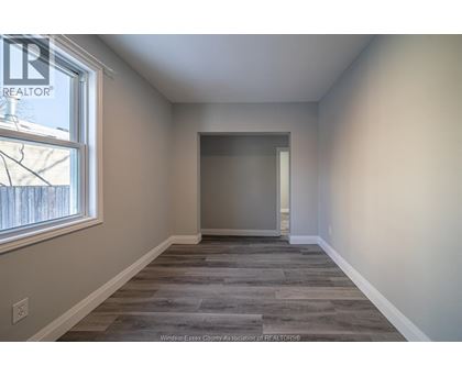A room with a window and a door is shown.