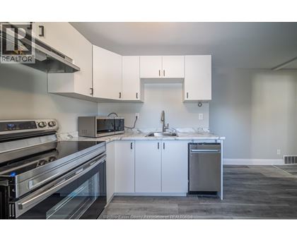 A kitchen with white cabinets and stainless steel appliances.