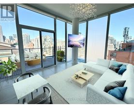 A modern living room with a large window overlooking the city.