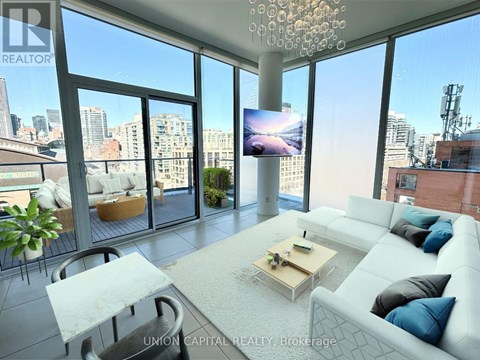 A modern living room with a large window overlooking the city.