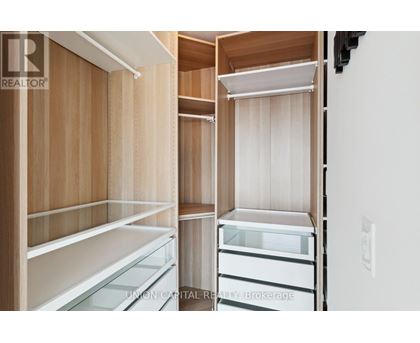 A kitchen with wooden cabinets and white appliances.