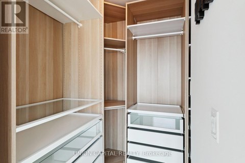 A kitchen with wooden cabinets and white appliances.