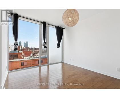 A room with a view of the city through large windows.