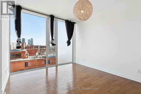 A room with a view of the city through large windows.