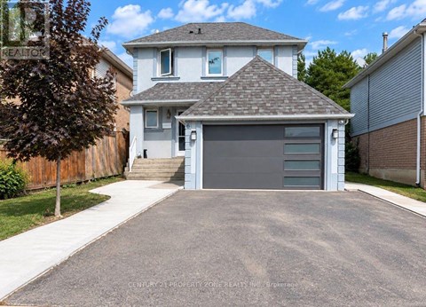 A house with a grey garage door in front of it.