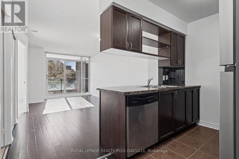 A kitchen with dark brown cabinets and a white countertop.