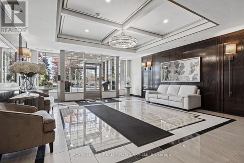 A spacious lobby with a marble floor and a large chandelier.