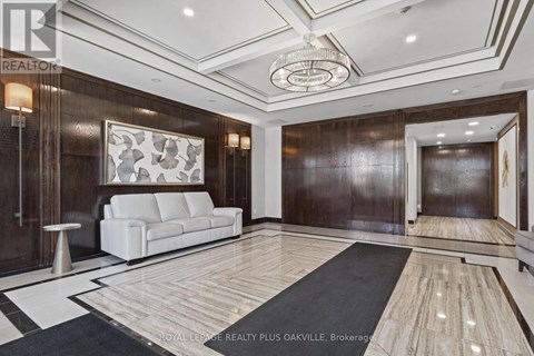 A spacious living room with a white sofa and a wooden floor.
